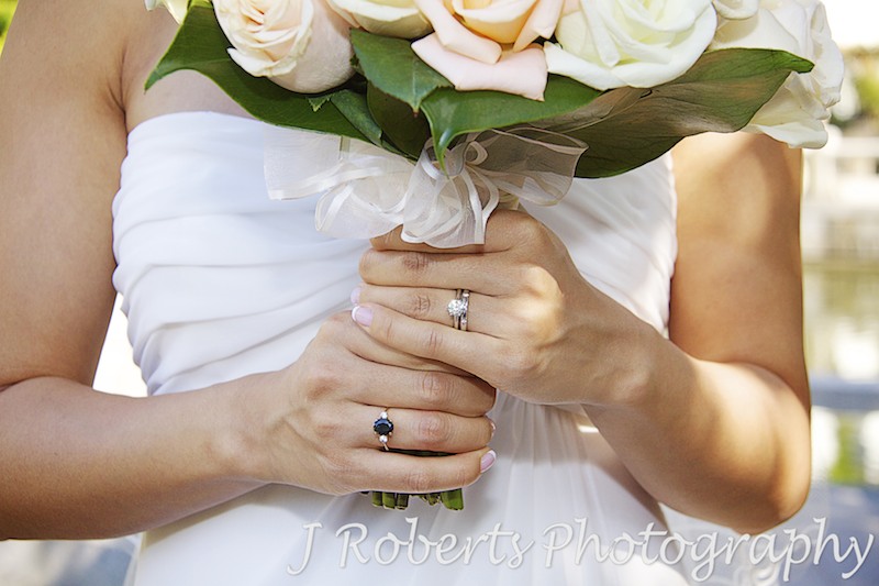 Bride holding bridal bouquet showing new wedding band - wedding photography sydney